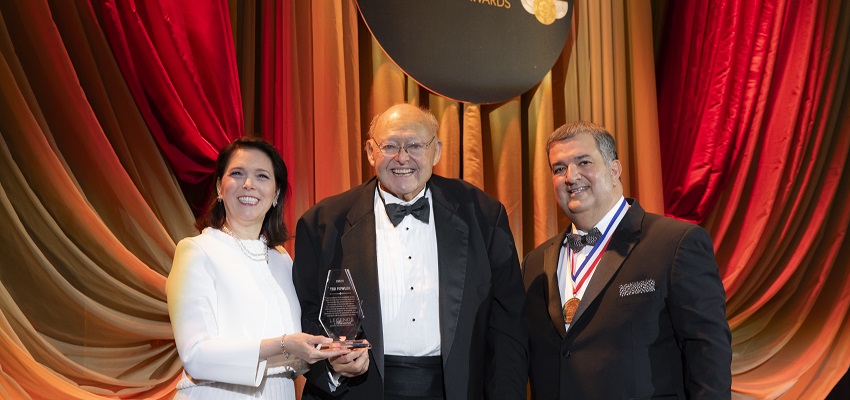  Michelle Korsmo, left, and Golden Corral President & CEO Lance Trenary, right, honor Ted Fowler at the Legends Award celebration.